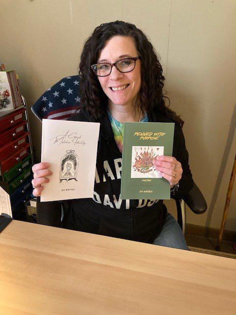 Lizzy holding her published books